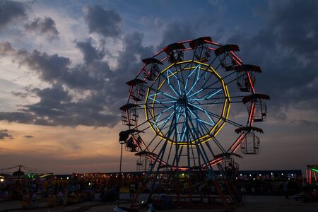 ferris fun wheel in  temple fair under twilight timeのeditorial素材