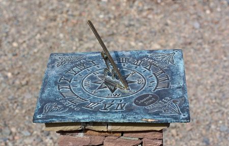 Sundial in a city garden on a pedestal from a stoneの写真素材