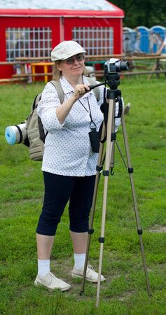 SHUSHENSKOE, Russia - JULY 9-11: Shushenskoe, the International festival of ethnic music "Sayan Ring". Woman doing a snapshot on a camera. July 9-11, 2010 in Shushenskoe, Russia.のeditorial素材