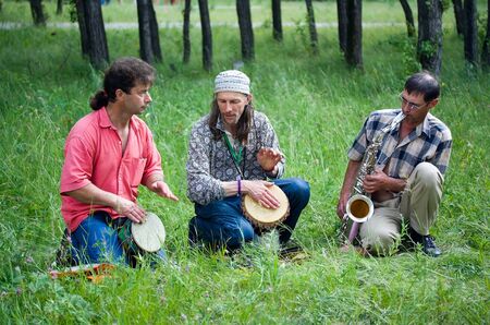 SHUSHENSKOE, Russia - JULY 9-11: Shushenskoe, the International festival of ethnic music "Sayan Ring". The group "Free drums" plays drums and a saxophone. July 9-11, 2010 in Shushenskoe, Russia.のeditorial素材