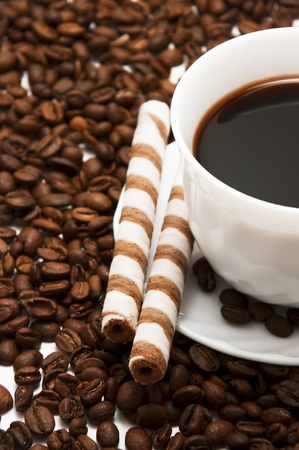 White cup of coffee with two sweet waffles の写真素材
