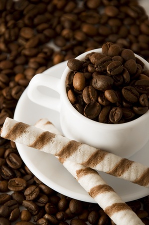 White cup with coffee beans with two sweet wafflesの写真素材