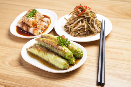 Various type of Chinese foods and chopsticks on table
