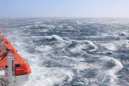 Lifeboats very rough seas and sunshineの写真素材