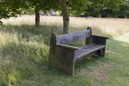 Old wooden park bench in the English countrysideの写真素材