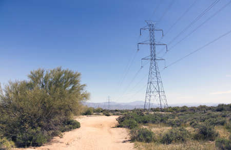 Electrical Power Lines cross the Desert in Southwestern USA bringing power to the citiesの写真素材