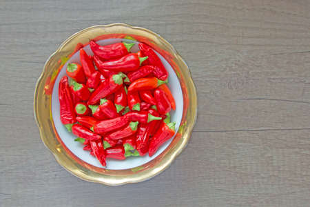 Spicy hot chilli peppers in a dishの写真素材