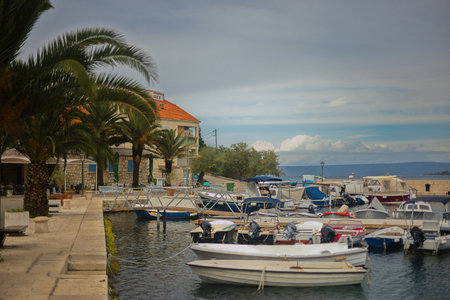 Sailboats and small fishing boats in the port of Korcula town in Croatia.の写真素材