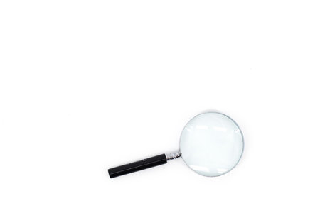 An image of a magnifying glass with a black handle and a silver rim around the magnifying glass, set against a pristine white backdrop.の写真素材