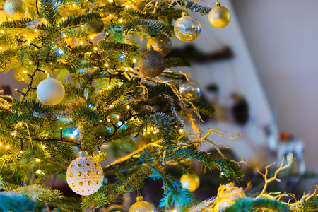 Hanging Ornaments Illuminate a Christmas Tree, Surrounded by the Soft Glow of Blurred Christmas...