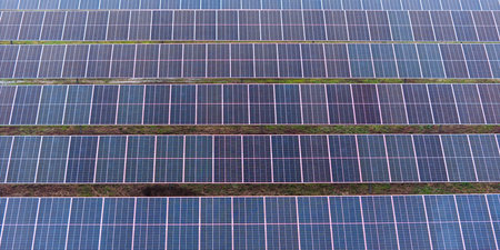 A picture showcasing a vast, contemporary photovoltaic solar farm.
