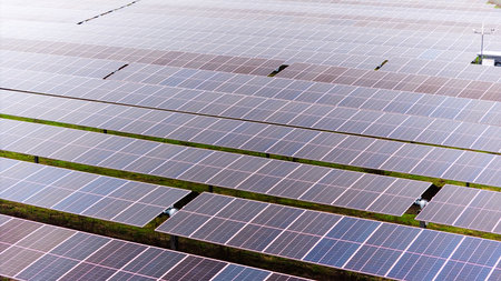 A picture showcasing a vast, contemporary photovoltaic solar farm.