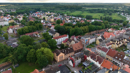 TrzebiatÃ³w's city center boasts a medieval Gothic red-brick church, with the 3rd tallest tower in Poland. The picturesque architecture reflects the town's rich history.の写真素材