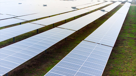A picture showcasing a vast, contemporary photovoltaic solar farm.