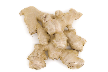 Whole ginger root photographed on crisp white, offering clear visibility of its rugged structure.