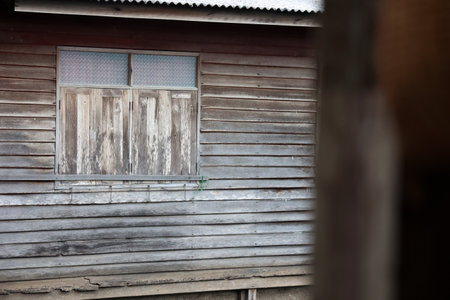 Old wooden wall and window in the village of Khao Yai, Thailandの写真素材