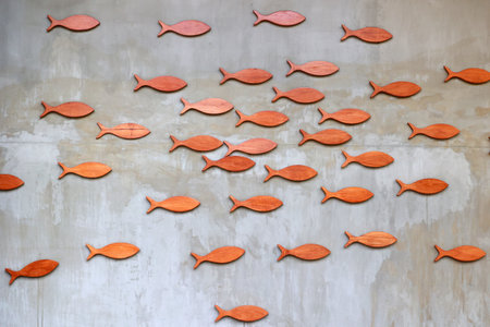 Wooden fish on the wall of the building, closeup of photoの写真素材