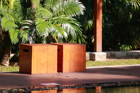 wooden stand beside the swimming pool in the garden at thailandの写真素材