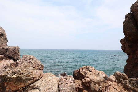 Rocky coast of the sea on a background of blue sky.の写真素材