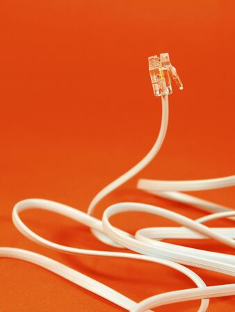 Telephone cable on orange backgroundの写真素材