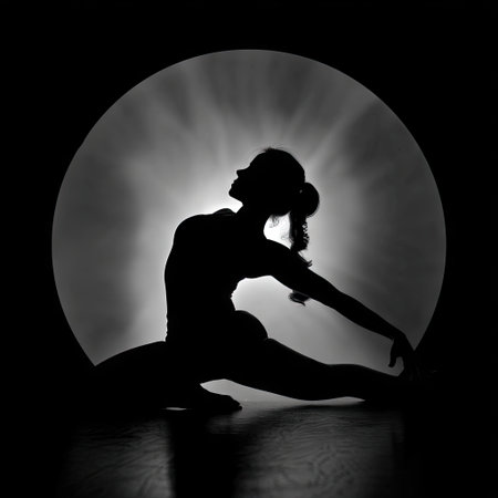 A stunning black and white image showcases a dancer's silhouette against a glowing circular light source, emphasizing the beauty of movement and artistic expression.の素材