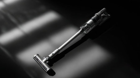 A sleek modern vacuum cleaner is elegantly presented against a dark background, highlighting its cutting-edge design and functionality for effective home cleaning.の素材