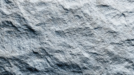 This image showcases a close-up view of a textured gray stone surface, capturing natural patterns and rugged details ideal for backgrounds and design.の素材