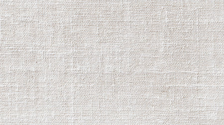 This image features a light beige textured fabric background, perfect for a variety of creative projects, including fashion, craft, and interior design applications.の素材