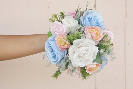 A stunning handheld bouquet featuring soft blue and pink flowers complemented by lush greenery, perfect for enhancing wedding ceremonies or special celebrations.の素材