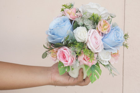 A stunning bouquet featuring soft blue and pink roses with delicate greenery, ideal for adding a touch of elegance to any event or interior setting.の素材