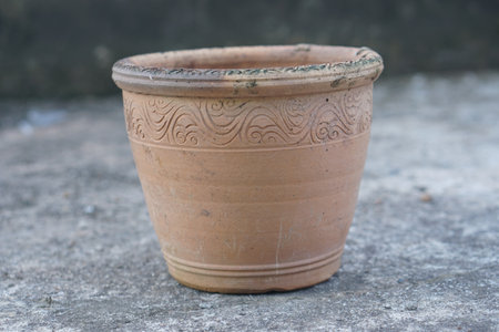 This rustic clay pot features intricate patterns and earthy tones, ideal for decorating homes or enhancing gardening spaces. Perfect for flower and plant displays.の素材