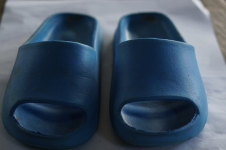A pair of blue slippers designed for comfort and style. These open-toe shoes are perfect for relaxing at home, providing a cozy experience for everyday use.の素材