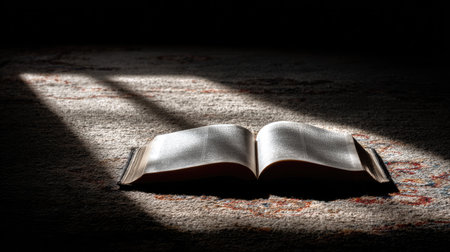 This image showcases an open book lying on a plush carpet, illuminated by soft light, creating a tranquil scene perfect for reflection and inspiration.の素材