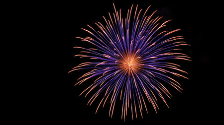 A breathtaking explosion of colorful fireworks illuminates the night sky, showcasing vibrant orange and purple hues in a mesmerizing display. Perfect for celebrations, events, or artistic visuals.の素材