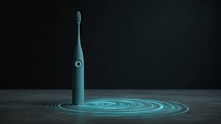 This image features a sleek electric toothbrush designed with modern aesthetics, surrounded by artistic blue light effects on a dark surface. Perfect for health and beauty themes.の素材
