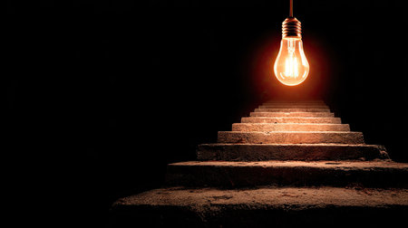 A captivating image featuring a single glowing light bulb illuminating a staircase, creating a serene atmosphere that symbolizes hope and ascension.の素材