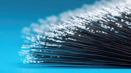 This close-up image showcases fine bristles of a brush set against a vibrant blue background, highlighting texture and detail ideal for artistic projects.の素材