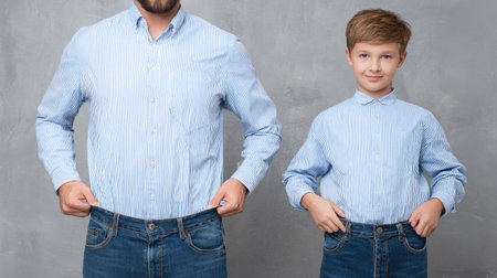 A lighthearted moment between a father and son as they try on oversized jeans, showcasing their playful interaction and joyful expressions in a stylish manner.の素材