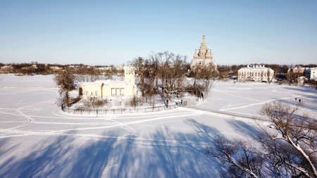 Frozen winter pond with an island.の写真素材