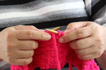 Hands of a young woman knittingの写真素材