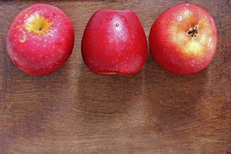 Three apples on the woodの写真素材
