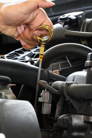 Mechanic check the oil in the engineの写真素材