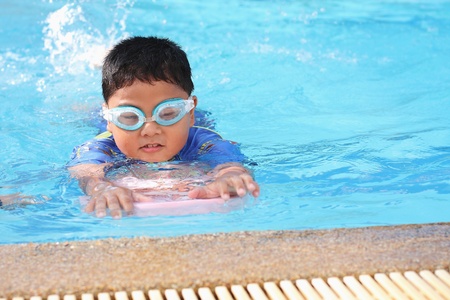 The boys were playing in the swimming pool 