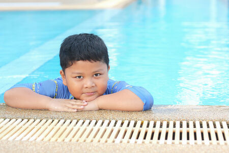 The boy was swimming in the pool.の写真素材