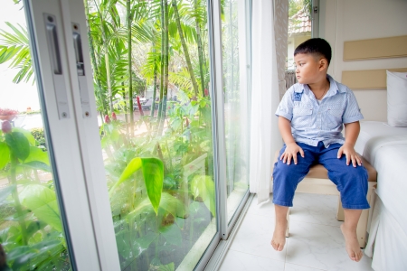 boy was sitting on the balconyの写真素材