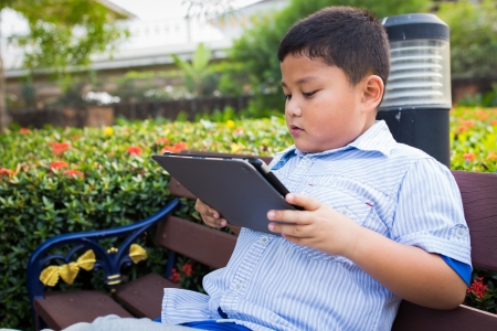Asian boy playing Tablet funの写真素材