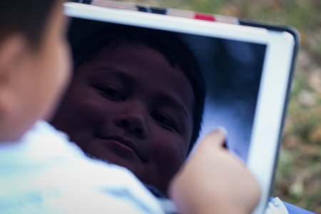 Asian boy playing Tablet funの写真素材