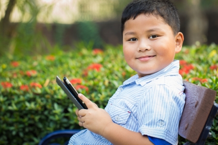 Asian boy playing Tablet funの写真素材