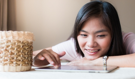 Asian beautiful women playing Tabletsの写真素材