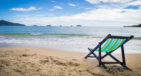 Wooden chairs rest at the beachの写真素材